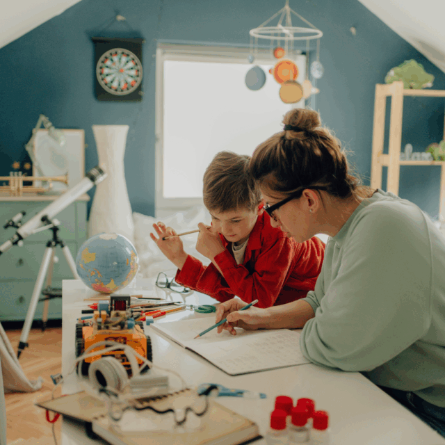 homeschool parent organizing curriculum materials at desk with math and science workbooks